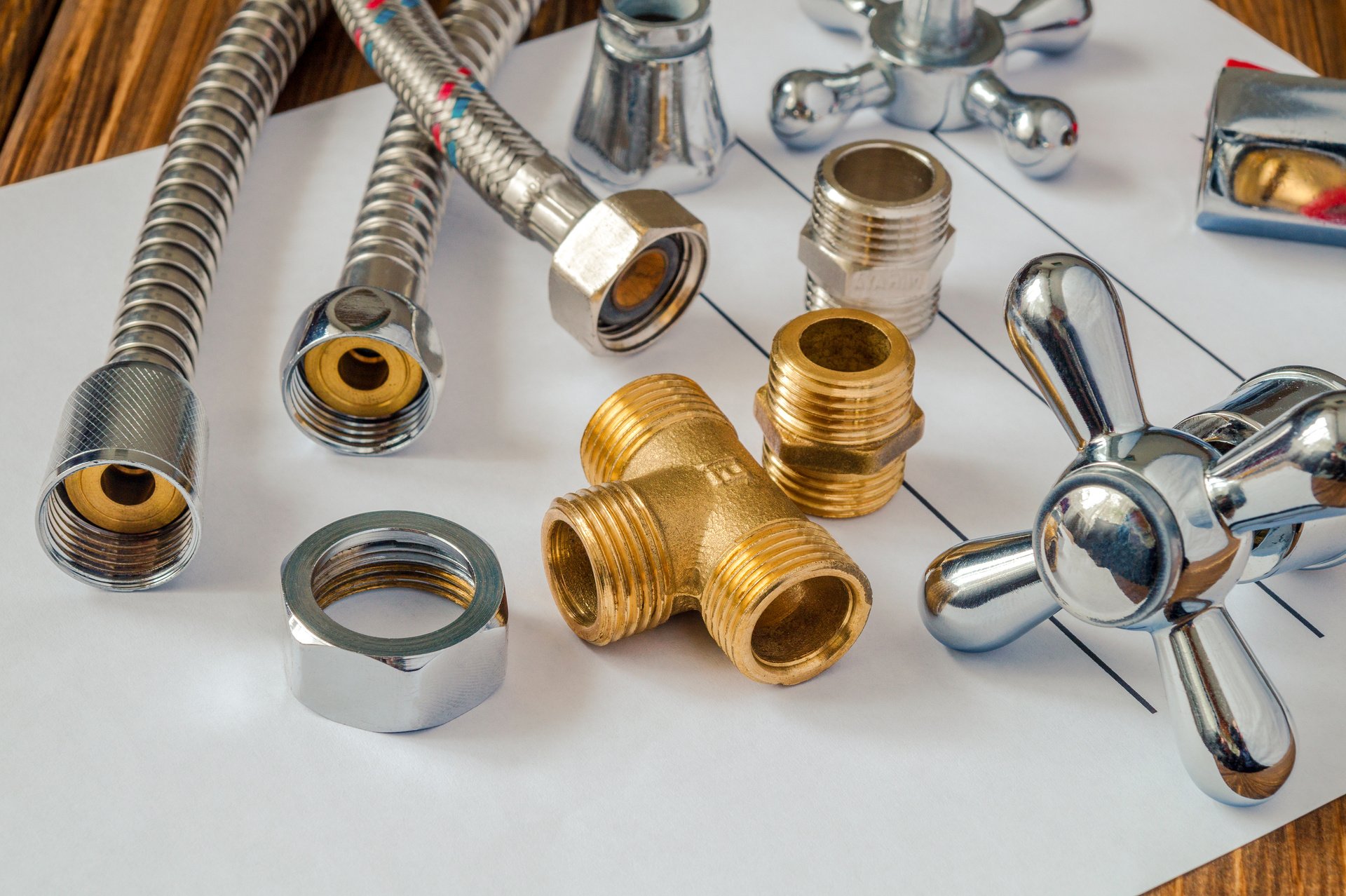 Spare parts with copper and plastic accessories for plumbing repair on a note sheet